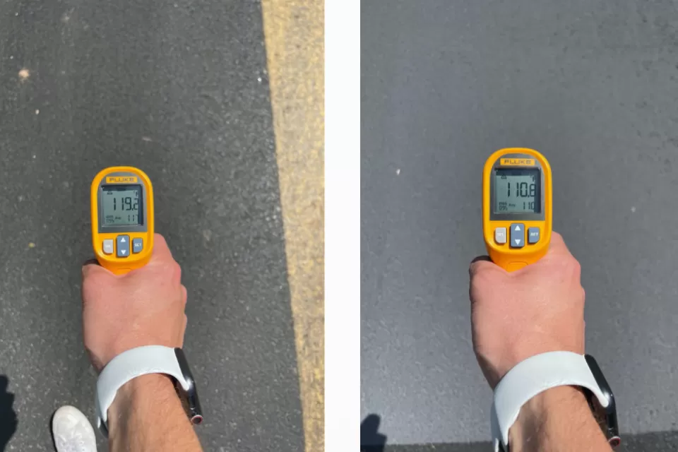 Side-by-side photos of hand holding thermometer above pavement; left photo shows 119 degrees, right photo shows 110 degrees, illustrating the effect of a cool pavement treatment.